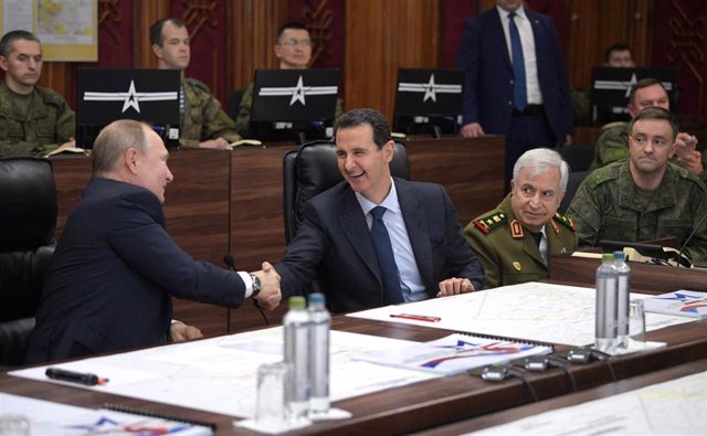 File - The president of Russia, Vladimir Putin (L), extends his hand to his Syrian counterpart, Bashar al Assad (R)