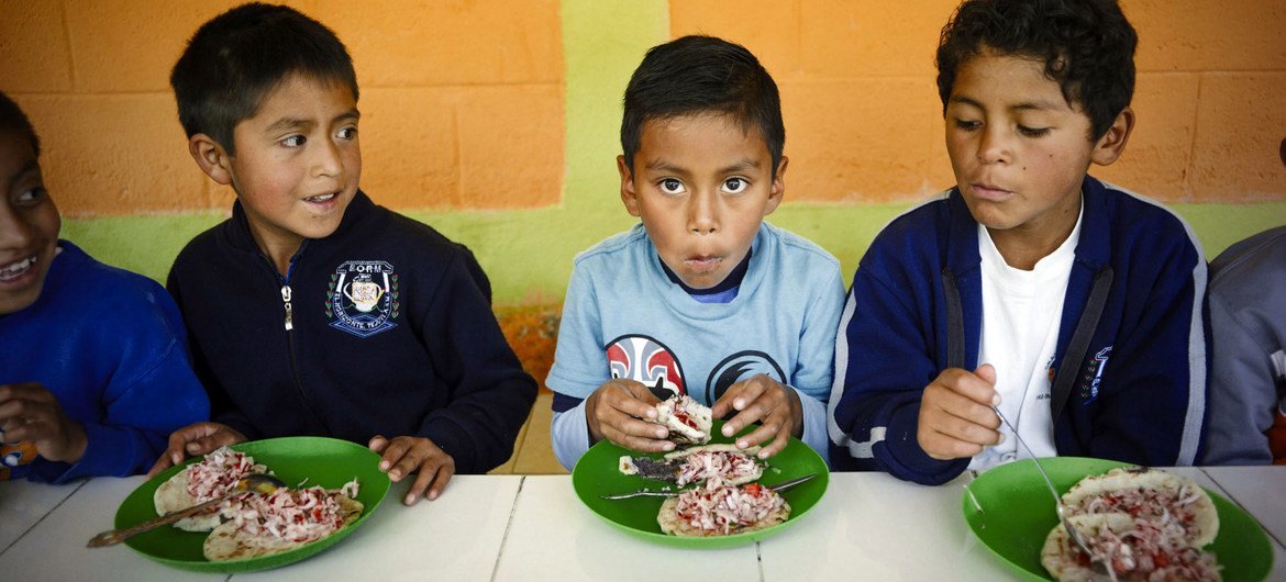 Some children eat their lunch at a school in Guatemala.