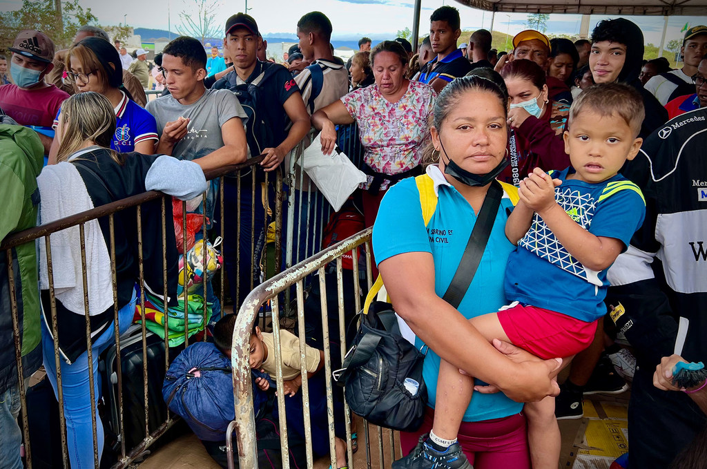 Venezuelan migrants and refugees line up in Pacaraima, a border town in northern Brazil.