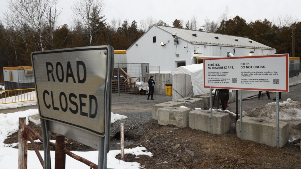 Royal Canadian Mounted Police officers guard the Roxham Road border crossing between the United States and Canada in Champlain, New York, on March 25, 2023. (Credit: LARS HAGBERG/AFP via Getty Images)