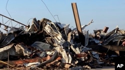 A mountain of rubble lies on the site of a structure torn apart by a tornado, Saturday, March 25, 2023, in Rolling Fork, Mississippi.