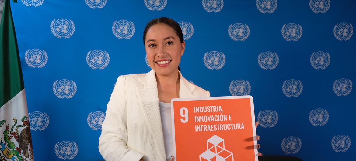 Katya Echazarreta poses with the logo of the Sustainable Development Goal number 9 related to industry, innovation and infrastructure.