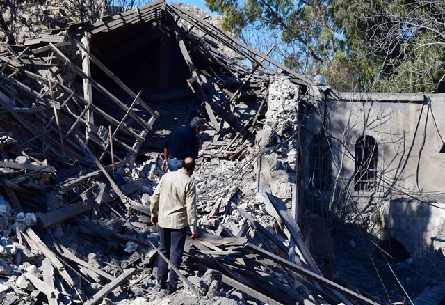 File - Syrian civilians checking the destruction caused by an Israeli missile in the historic center of Damascus, the country's capital, on February 21, 2023