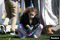 A girl holds an Easter egg during the Easter Egg ceremony at the White House on April 10, 2023.