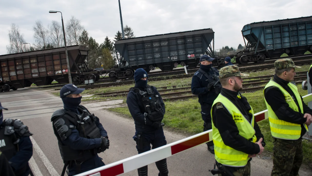 Police and border guards protect a train carrying Ukrainian grain at the broad gauge railway crossing in Hrubieszow, Poland on April 12, 2023. (Credit: Attila Husejnow/SOPA Images/LightRocket/Getty Images)