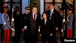 Taiwan's President Tsai Ing-wen walks with her Guatemalan counterpart Alejandro Giammattei at the National Palace of Culture, in Guatemala City, Guatemala, March 31, 2023. REUTERS/Luis Echeverria