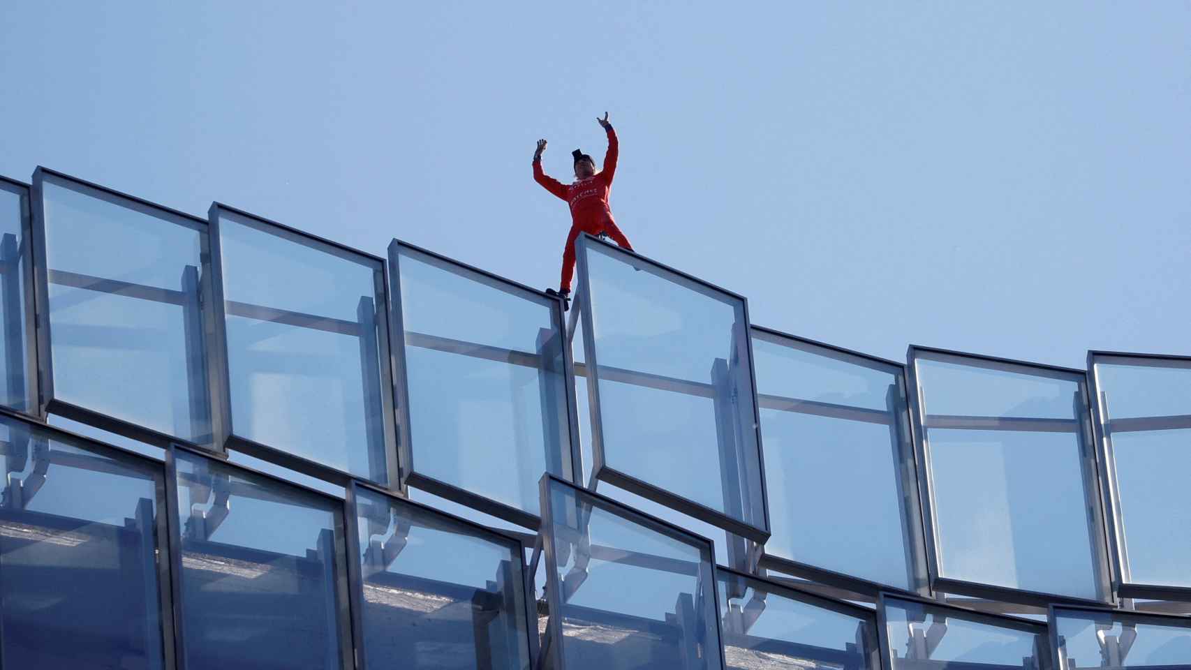 French Spiderman Alain Robert scales a skyscraper to protest pension reform.