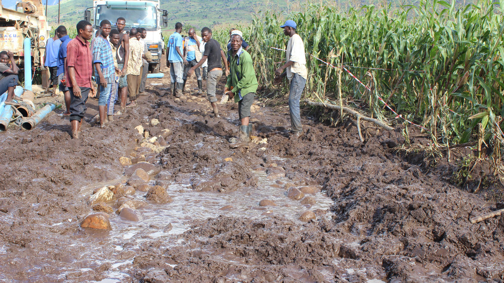 Several men work to repair a damaged road in the Mulanje district of Malawi in the aftermath of Cyclone Freddy.