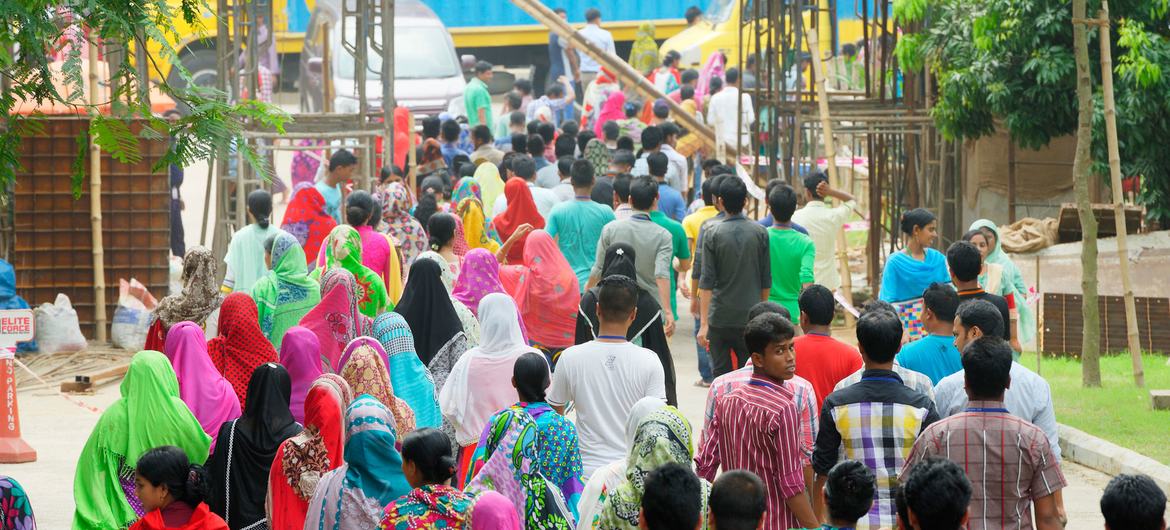 Bangladeshi garment workers leave a garment factory at the end of their workday.