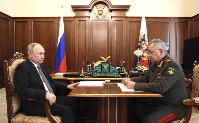 FILE - Russian President Vladimir Putin and Defense Minister Sergei Shoigu.