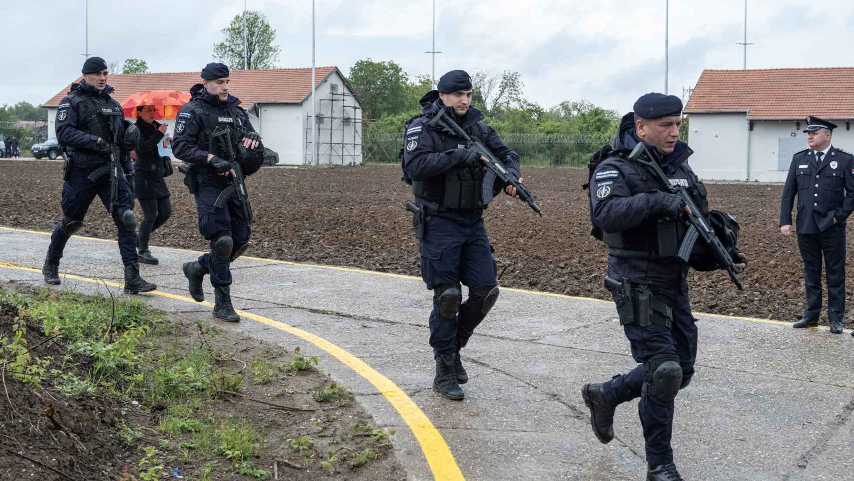 Armed police officers walk past the warehouses where weapons were handed over to police in the first ten days of the arms amnesty after mass shootings in the country, near Smederevo, Serbia, on May 14, 2023.