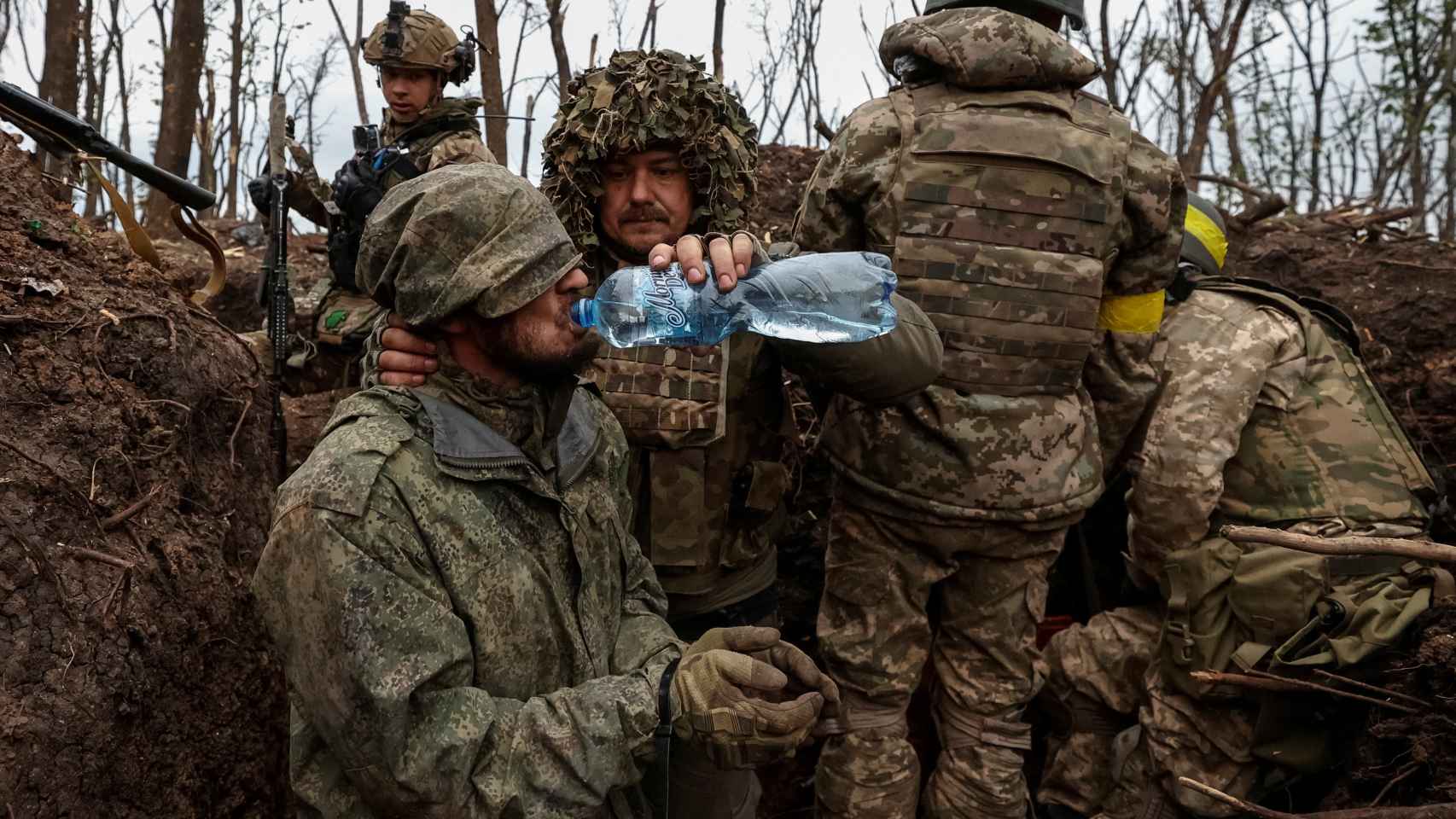 A Ukrainian soldier gives water to a captured Russian soldier near the battle line in Bakhmut on Friday.