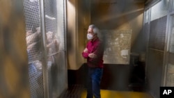 FILE - Award-winning journalist José Rubén Zamora, inside a cell after a court hearing, in Guatemala City, Saturday, July 30, 2022. (AP Photo/Moisés Castillo, File)