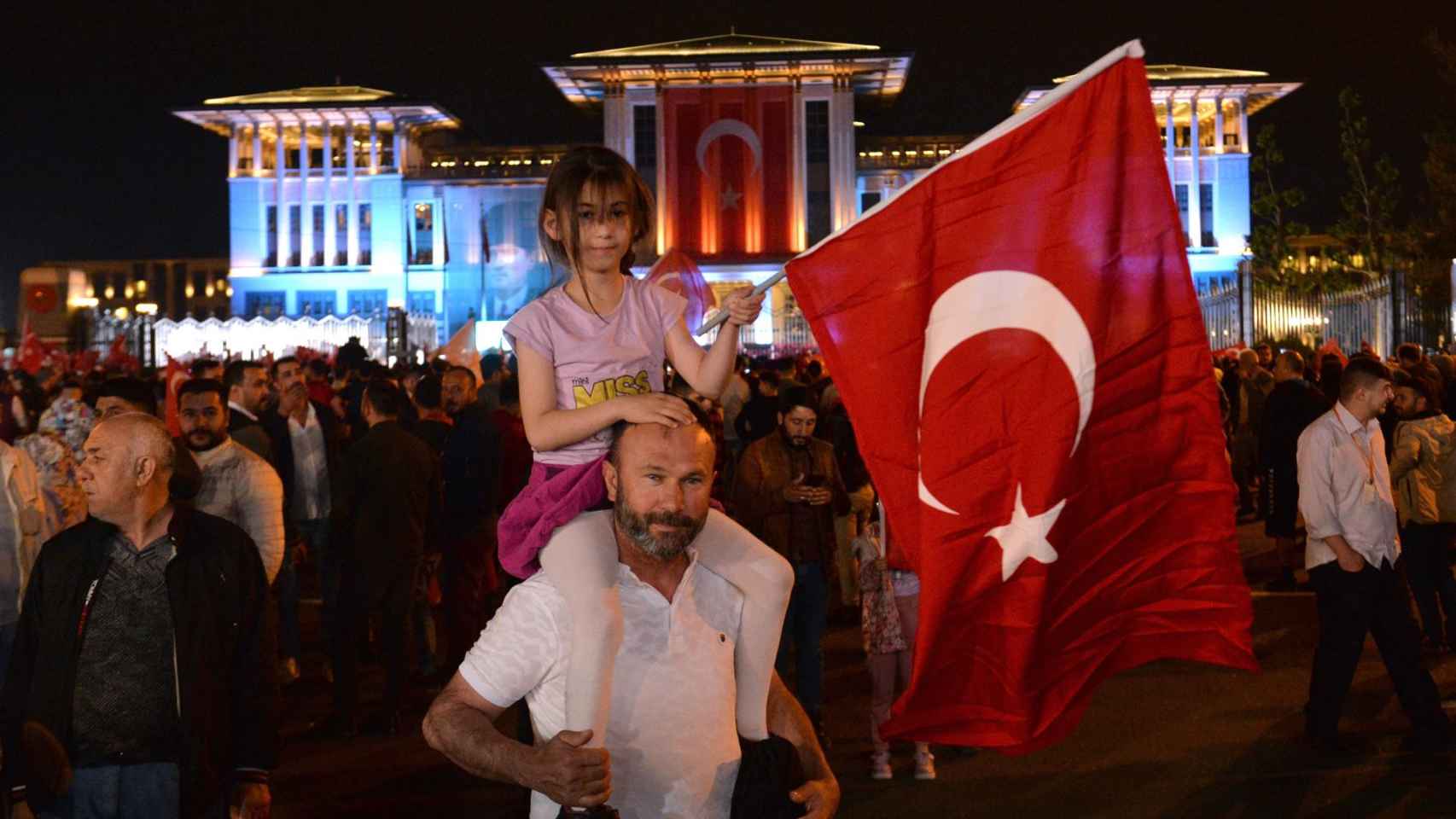 Supporters gather to listen to Turkish President Recep Tayyip Erdogan give a speech after winning re-election in Turkey.