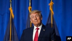 Former President Donald Trump gestures before approaching a microphone to address an audience at the New Hampshire Federation of Lilac Republican Women Luncheon, Tuesday, June 27, 2023, in Concord.