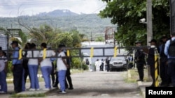 Forensic technicians work at the Centro Femenino de Adaptación Social (CEFAS) women's prison after a deadly riot in Tamara, on the outskirts of Tegucigalpa, Honduras, on June 20, 2023.