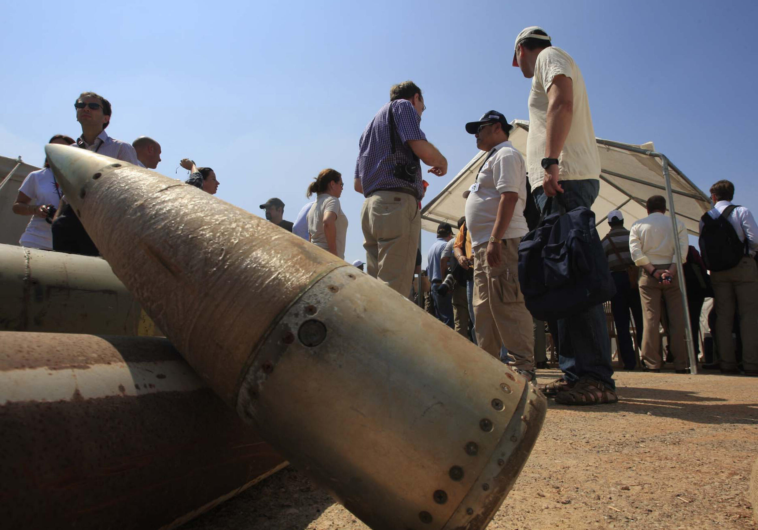 FILE - International activists and delegations stand with cluster bomb units during a visit to a Lebanese military base at the opening of the Second Meeting of States Parties to the Convention on Cluster Munitions, in the southern city of Nabatiyeh, Lebanon, September 12, 2011. The Biden administration has decided to provide cluster munitions to Ukraine and is expected to announce on Friday, July 6, 2023 that the Pentagon will send thousands as part of the latest military aid package for the war effort against Russia, according to people familiar with the decision.