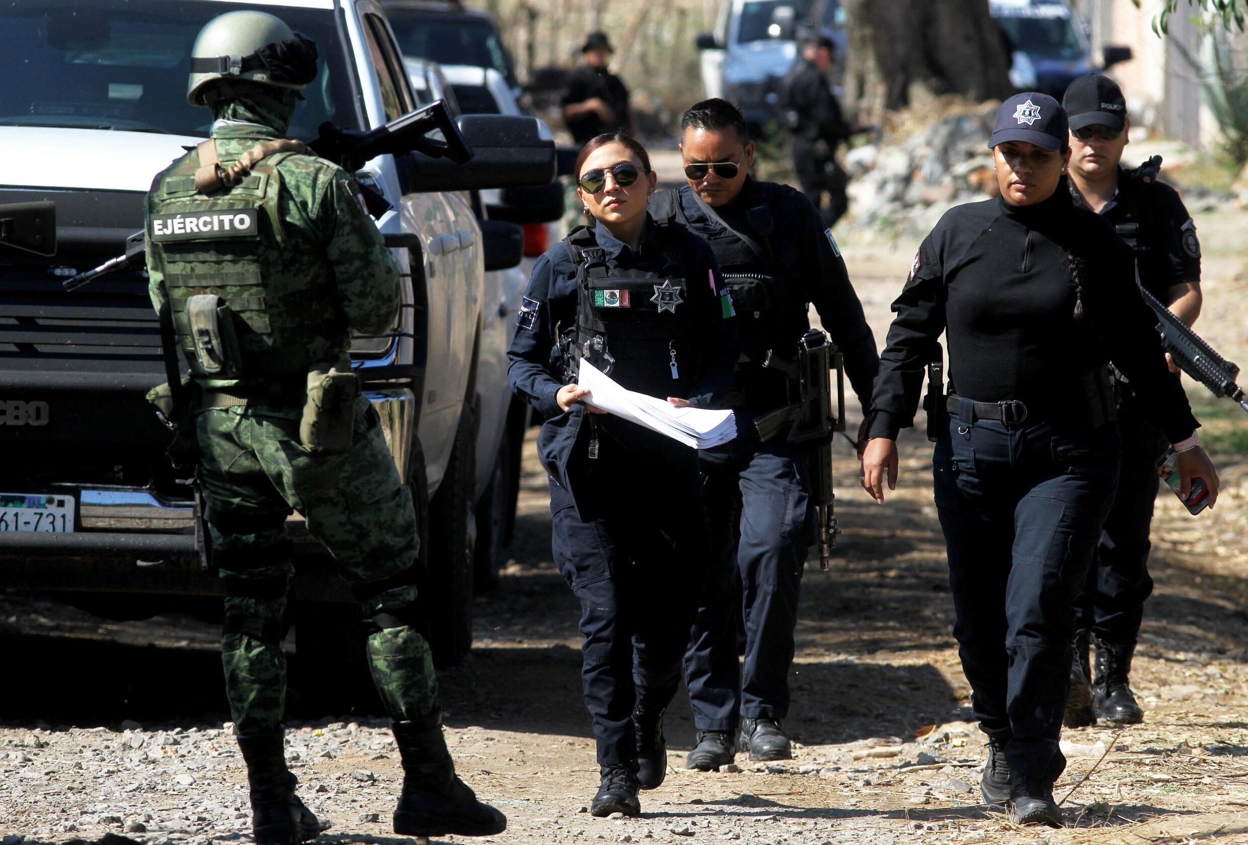 Members of the Mexican Army and Police work at the scene of a bombing attack against a police patrol in Tlajomulco de Zúñiga, a suburb in the city of Guadalajara, Jalisco state, Mexico, on July 12, 2023.