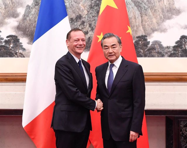 File - The foreign policy advisers to the French and Chinese Presidencies, Emmanuel Bonne and Wang Yi, respectively.