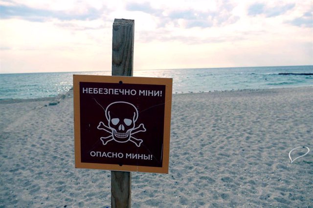 File - A sign warning of the danger of mines on a beach in the city of Odessa, in southern Ukraine