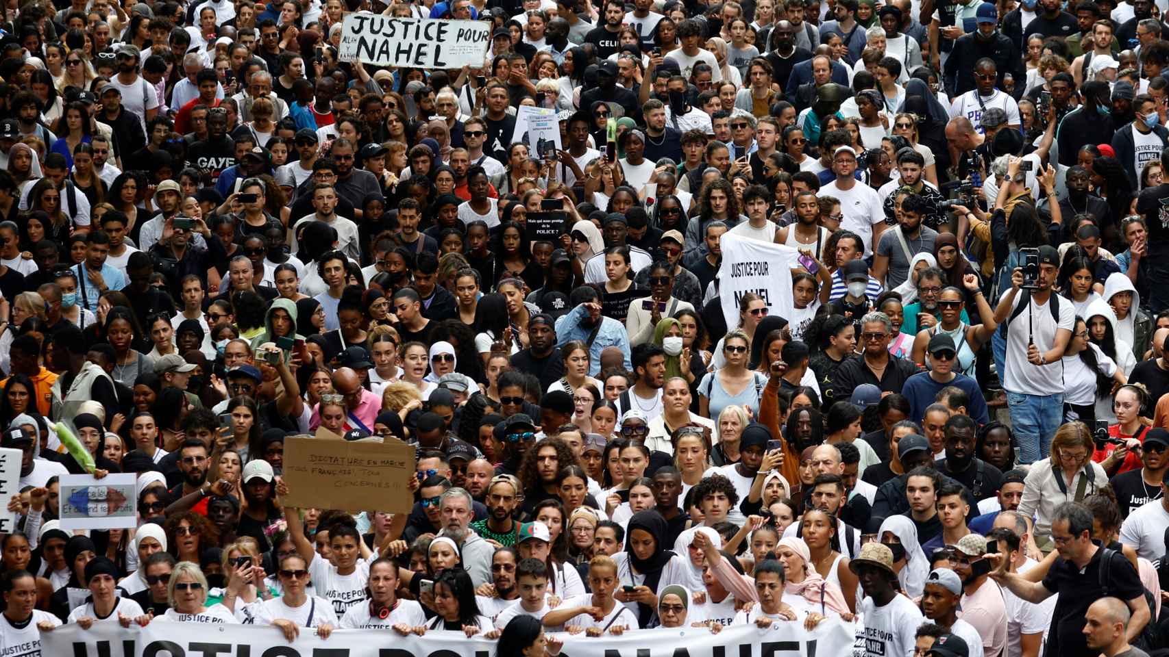 People attend a march in tribute to Nahel, a 17-year-old teenager killed by a French police officer during a traffic stop, in Nanterre, a suburb of Paris, France.