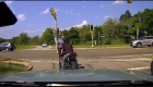 Watch a motorcyclist exhaust from a traffic stop