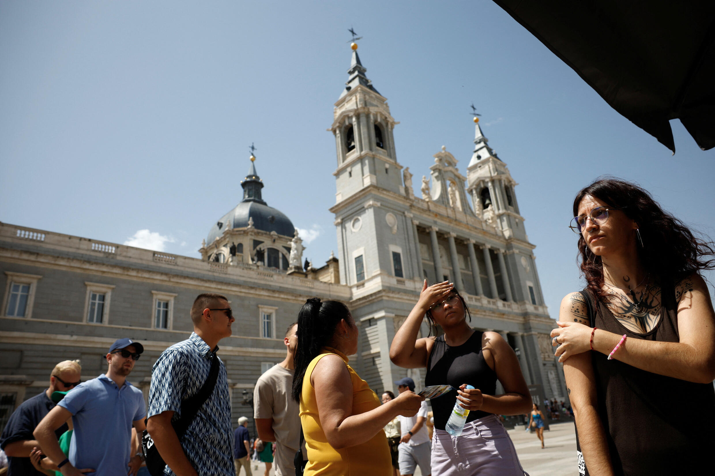 A group of tourists queue to enter the Royal Palace museum, amid an intense heat wave, in Madrid, Spain, on July 17, 2023.