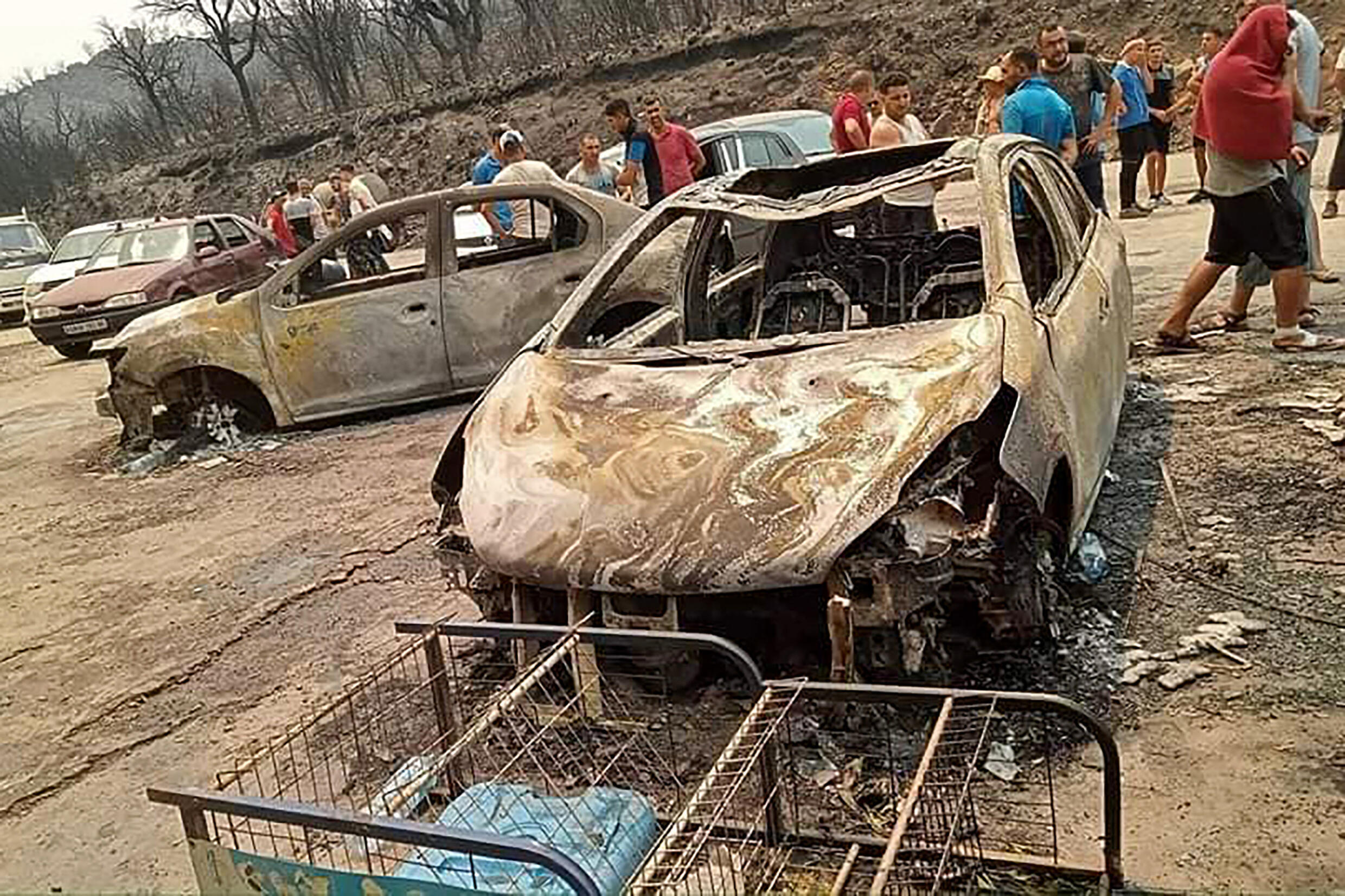 This image released by the Radio Soummam Bejaia Facebook page on July 24, 2023 shows the aftermath of forest fires in the Algerian city of Toudja, where temperatures reached 48 degrees Celsius (118 Fahrenheit).  Forest fires raging in Algeria at the height of a heat wave have killed at least 15 people and forced mass evacuations, according to the government.