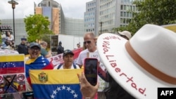 Protesters hold Venezuelan flags as they take part in a demonstration, on the first day of a European Union-Community of Latin American and Caribbean States (EU-CELAC) summit in Brussels, Belgium, on July 17, 2023.