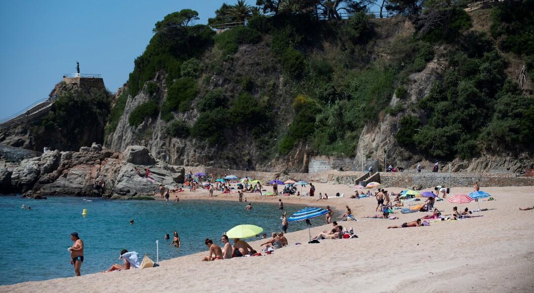 File-Dozens of people enjoy a day on a beach, amid the reopening to tourism, in Lloret de Mar, Spain, on June 22, 2020.