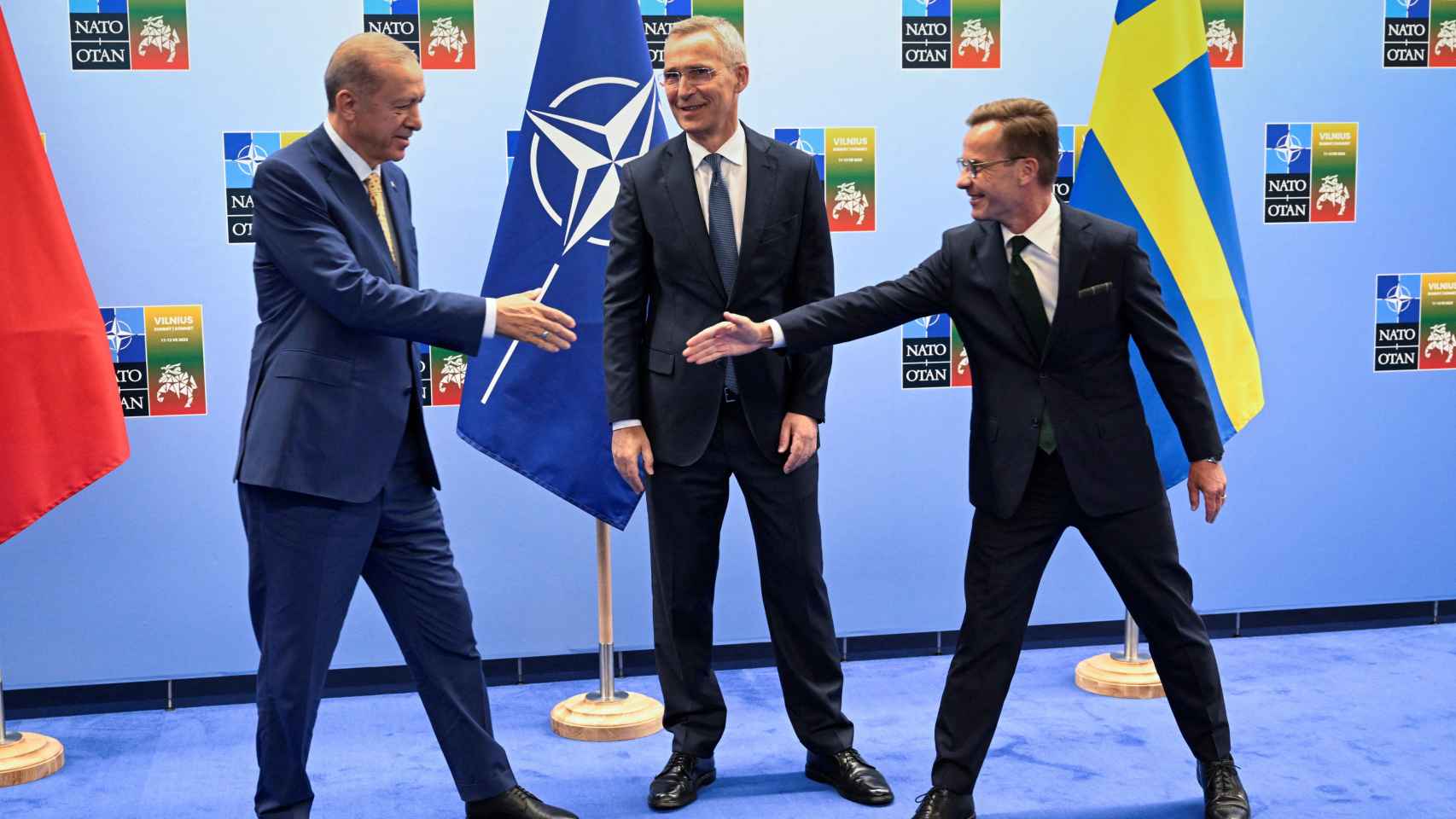 Turkish President Erdogan and Swedish Prime Minister Kristersson shake hands with NATO Secretary General Stoltenberg before their meeting in Vilnius.