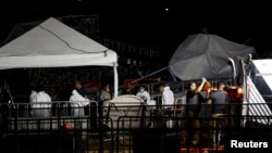 Emergency personnel work at the scene after a gust of wind caused a structure to collapse during an election rally in San Pedro Garza García, Nuevo León, Mexico, on May 22, 2024.