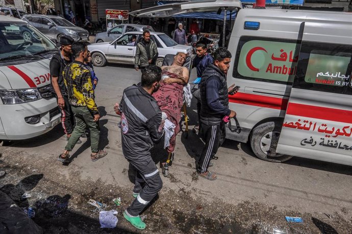 File - Archive photograph of the transfer to Al Nayar Hospital in Rafah, in the Gaza Strip, of a Palestinian injured in an Israeli bombing near a warehouse of the United Nations Agency for Palestine Refugees in the Near East (UNR