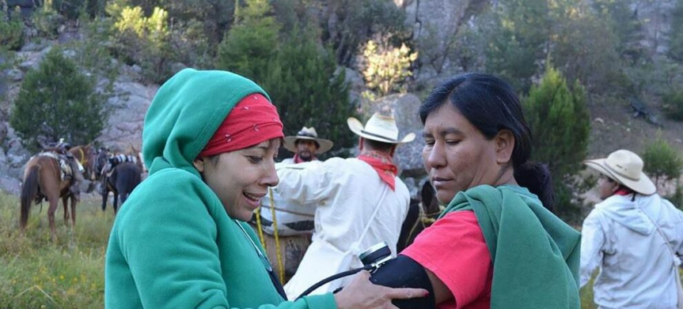 Julia Paredes takes the blood pressure of an indigenous woman in the mountains.