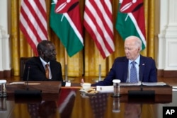 US President Joe Biden and Kenyan President William Ruto shake hands as they meet with business leaders in the East Room of the White House in Washington on May 22, 2024.