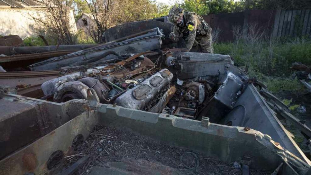 An International Legion soldier inspects the remains of a Russian armored vehicle in Bilohorivka.