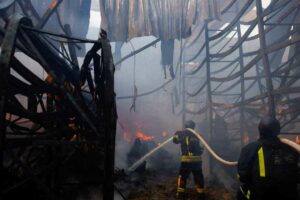 Firefighters put out the fire in the supermarket bombed by Russia in Kharkiv.