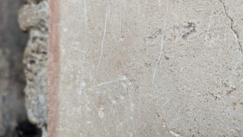 A tourist was arrested in Pompeii after being caught red-handed recording his name on a wall