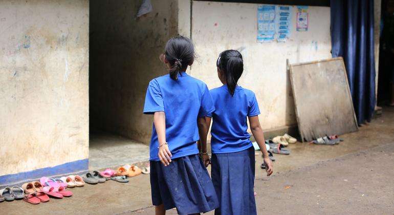 Two girls return to class at a learning center for immigrants.