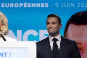 Marine Le Pen and Jordan Bardella give a speech at the National Rally party in Paris on Sunday.