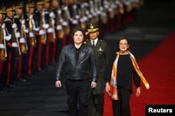 The president of Argentina, Javier Milei, with the Minister of Foreign Affairs of El Salvador, Alexandra Hill Tinoco, upon arrival to participate in the inauguration ceremony for the second term of President Nayib Bukele, in San Luis Talpa, El Salvador, on May 31, 2024.