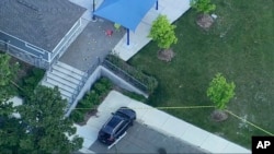 Police are on the scene of a shooting at Brooklands Plaza Splash Pad, Saturday, June 15, 2024, in Rochester Hills, Michigan.