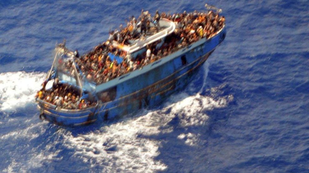 Migrants aboard a boat during a rescue operation before their boat capsized in the open sea.