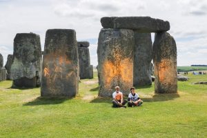 Two activists spray paint on Stonehenge to demand end to fossil fuels