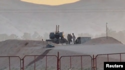 In this screenshot taken from a video, military personnel stand guard at a nuclear facility in the Zardanjan area of ​​Isfahan, Iran, April 19, 2024. (West Asia News Agency via Reuters)