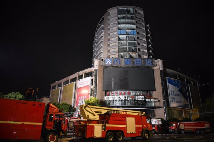 ZIGONG, July 18, 2024 -- This photo taken on July 18, 2024 shows firefighting vehicles at the site of a department store fire in Zigong City, southwest China's Sichuan Province.  The rescue operation at the site of the department store fire in Zigong City