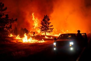 Firefighters battle massive California wildfire in cooler weather