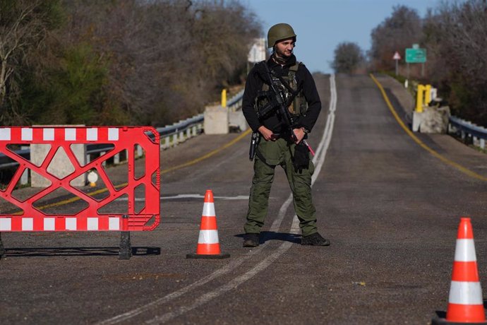 File - KIRYAT SHMONA, Jan. 7, 2024 -- An IDF soldier stands guard at a temporary checkpoint on a road in northern Israel, near the border with Lebanon, Jan. 6, 2024. About 40 rockets were fired from Lebanon targeting northern Israel on Saturday following