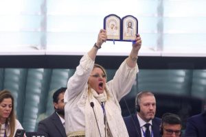 The Romanian MEP with religious images before being expelled from the chamber.