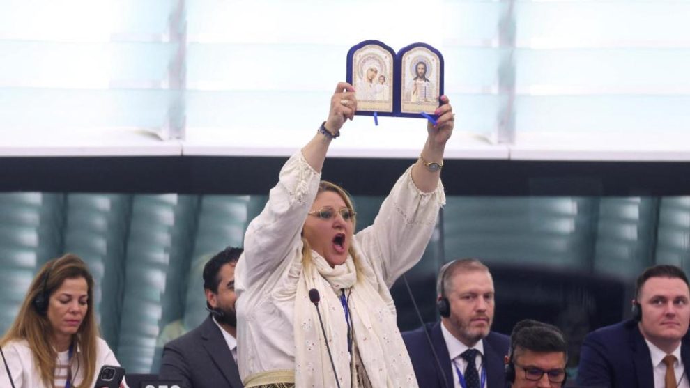 The Romanian MEP with religious images before being expelled from the chamber.